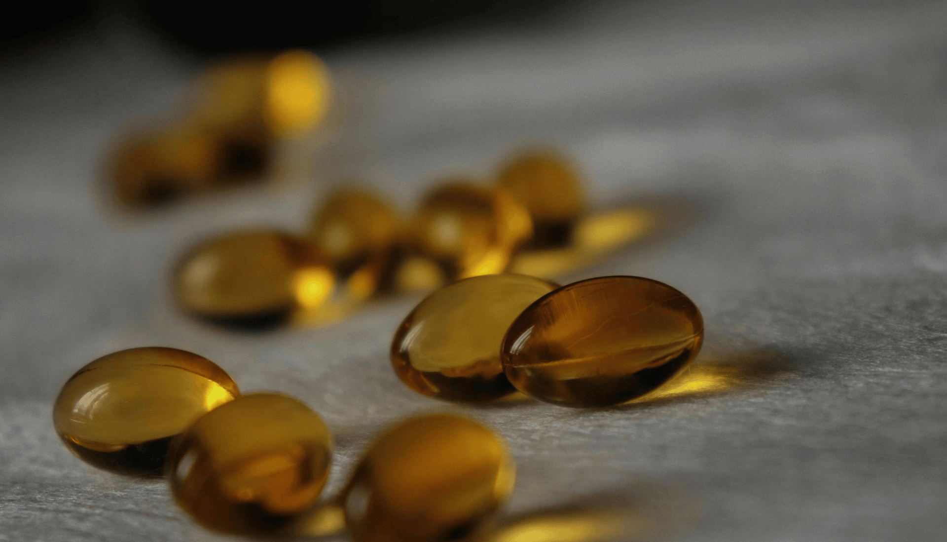Yellow capsules on a gray surface