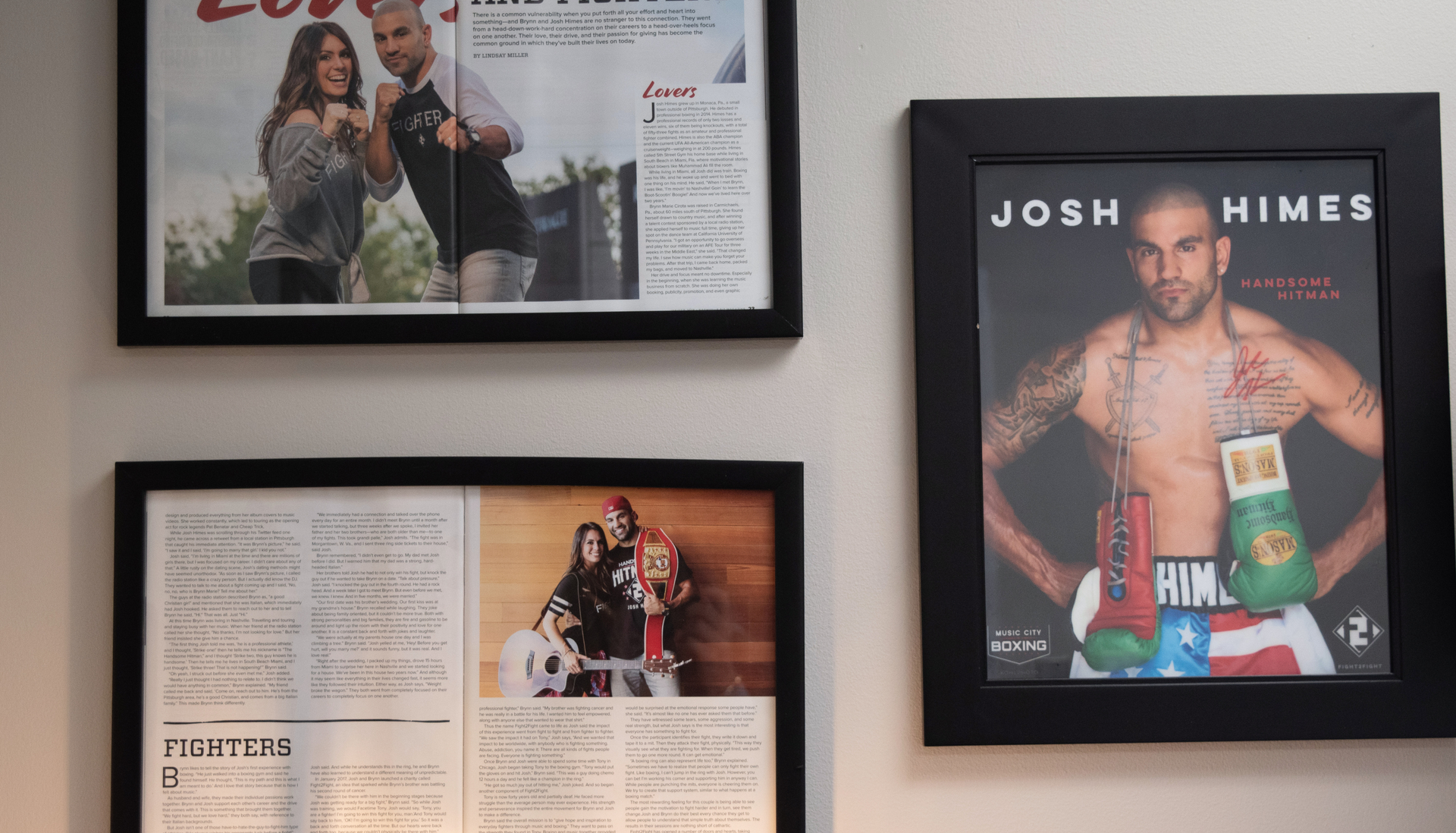 Framed magazine covers featuring a couple and a boxer on a wall.