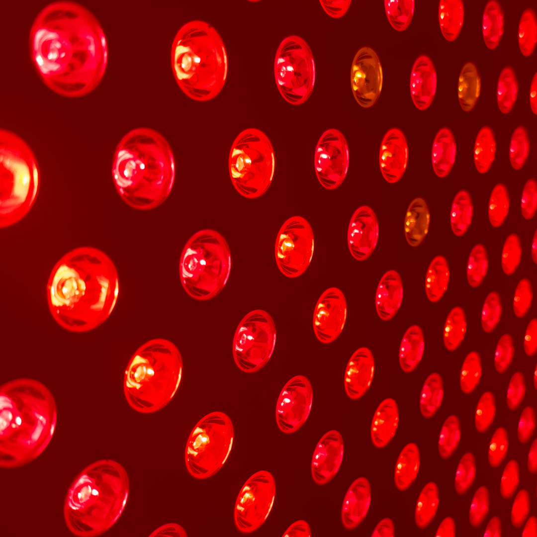 Close-up of a red LED light panel with a grid pattern.