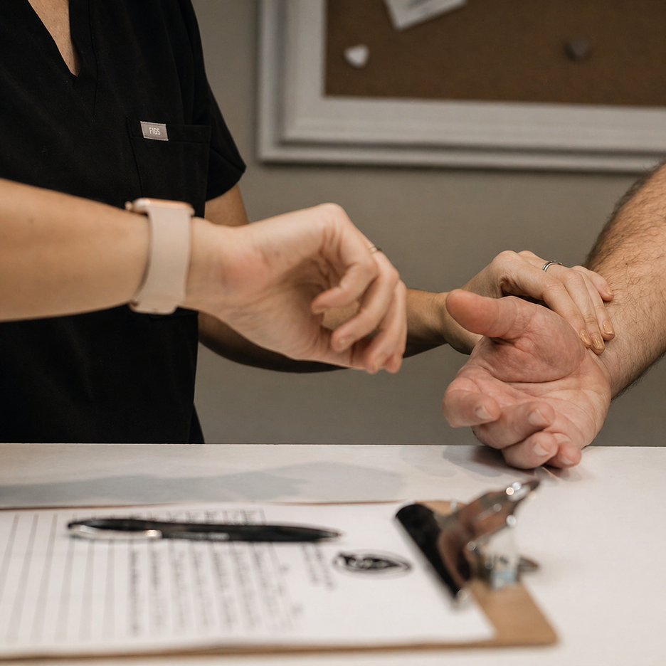 Nurse taking pulse vital at desk.
